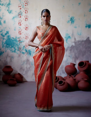 Rust orange half and half saree with sleeveless blouse