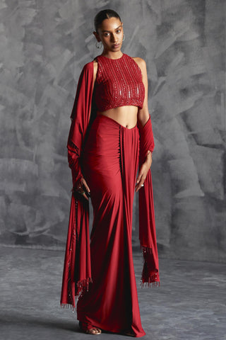 Red fitted broad pleat reim skirt with backless embellished blouse