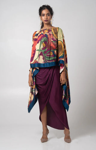 Deep purple free size poncho paired with a draped skirt