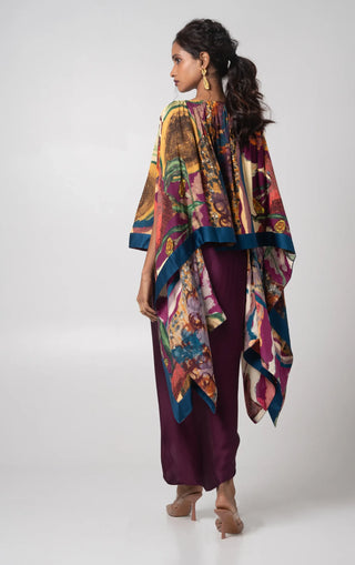 Deep purple free size poncho paired with a draped skirt