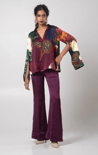 Purple V-neck top paired with a solid flared trouser