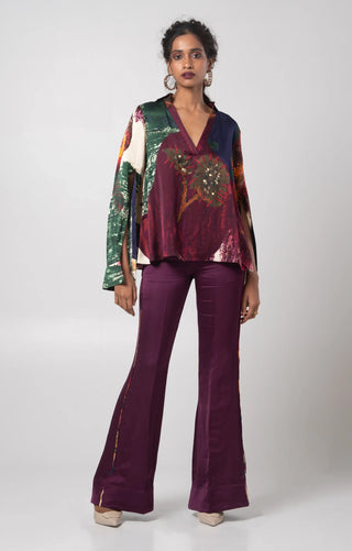 Purple V-neck top paired with a solid flared trouser