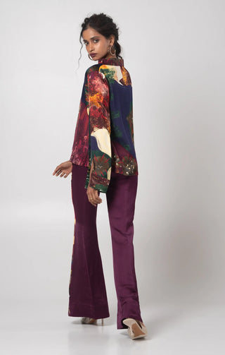 Purple V-neck top paired with a solid flared trouser