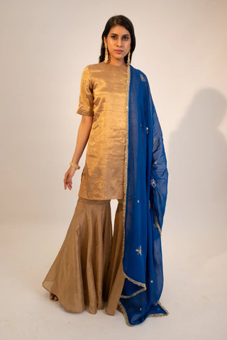 Beige zari tissue gold kurti & garara paired with electric blue dupatta