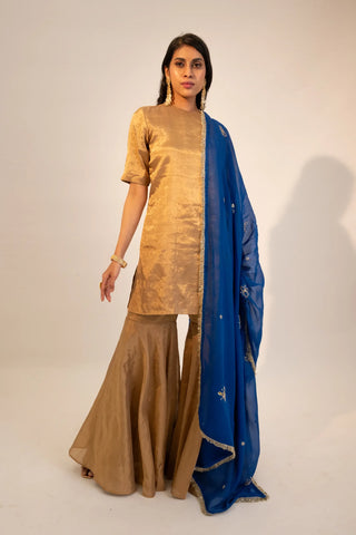 Beige zari tissue gold kurti & garara paired with electric blue dupatta