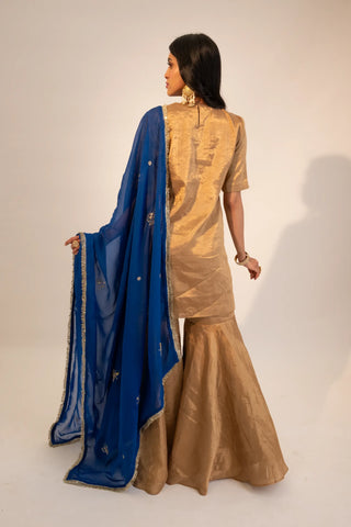 Beige zari tissue gold kurti & garara paired with electric blue dupatta