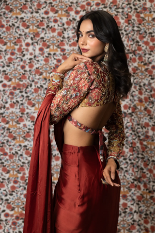 Maroon draped saree paired with printed top