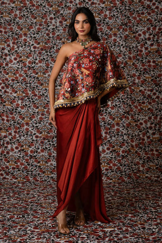 Maroon one-shoulder printed top paired with a draped skirt