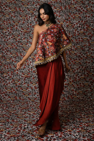 Maroon one-shoulder printed top paired with a draped skirt