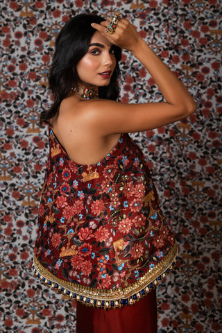 Maroon one-shoulder printed top paired with a draped skirt