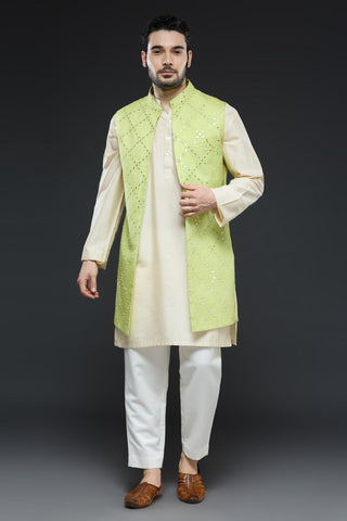 Ivory kurta and slim pant set paired with bright green long open jacket