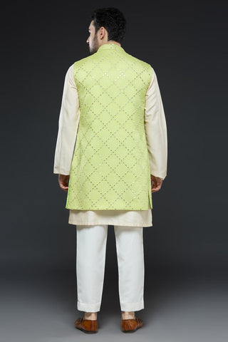 Ivory kurta and slim pant set paired with bright green long open jacket