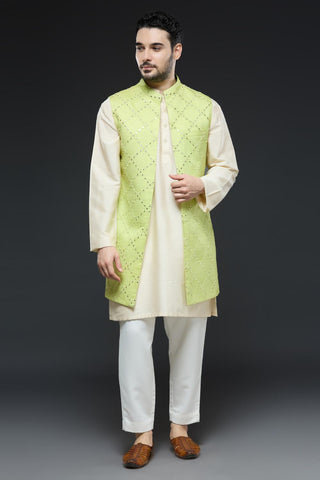 Ivory kurta and slim pant set paired with bright green long open jacket