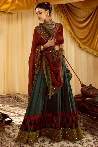 Teal lehenga with rust pararambh choli & hand embroidered dupatta