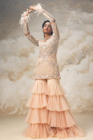 Peach embroidered short kurta paired with ruffle sharara and dupatta