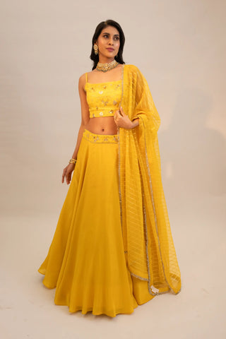 Yellow embroidered lehenga and blouse paired with dupatta