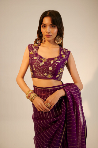 Purple embroidered organza saree paired with blouse