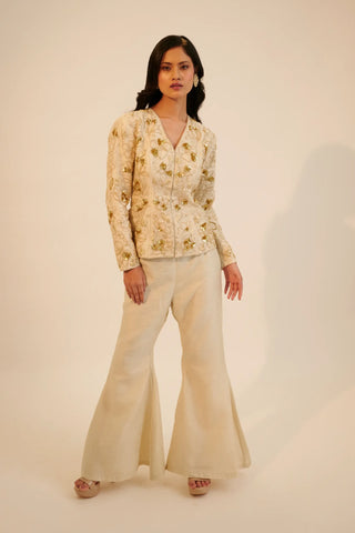 Ivory embroidered top paired with bell bottom pants