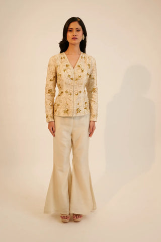 Ivory embroidered top paired with bell bottom pants