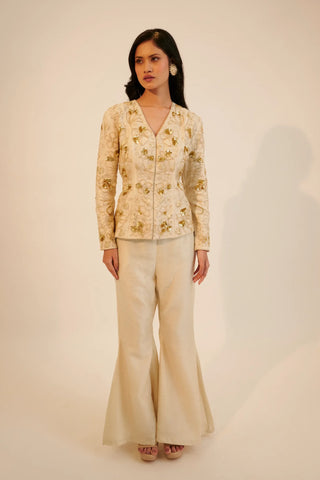 Ivory embroidered top paired with bell bottom pants