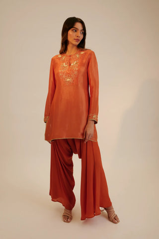 Rust embroidered short kurta paired with cowl pants