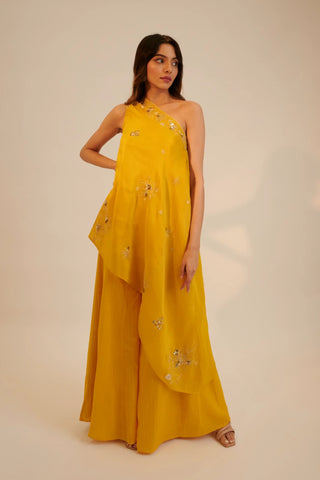 Yellow one shoulder asymmetric top paired with pants