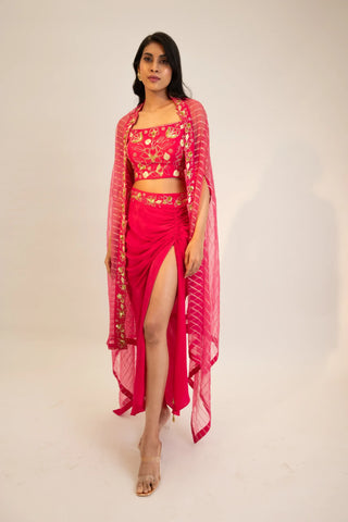 Pink embroidered blouse paired with slit skirt, belt and cape