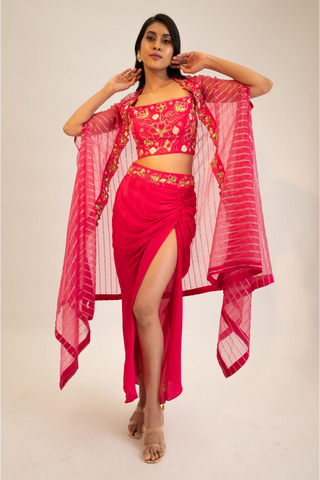 Pink embroidered blouse paired with slit skirt, belt and cape